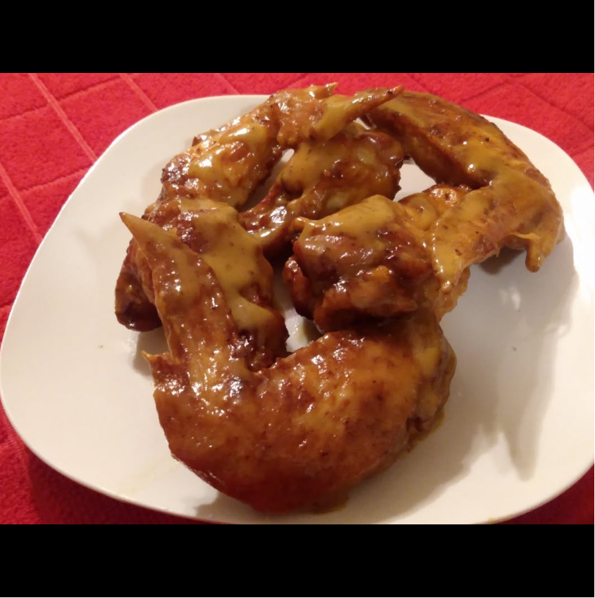 Gold Rush wings covered with that gold BBQ sauce red white background